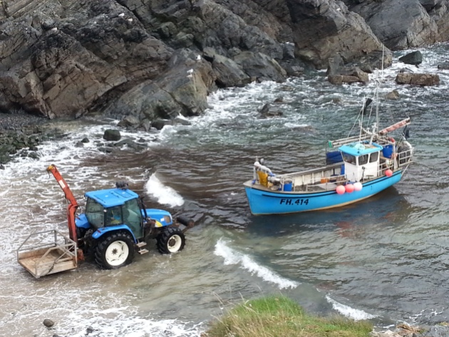 Tractor pulling a fishing boat