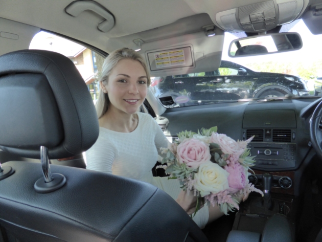 Bride waiting nervously in the car before the ceremony